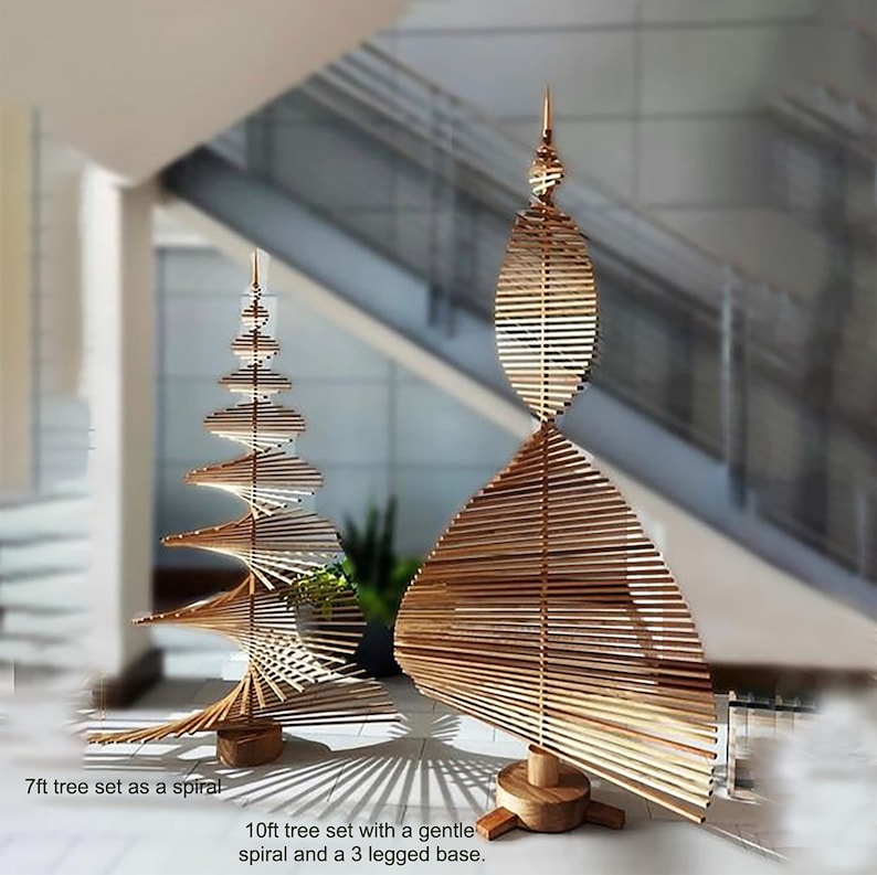 May include: Two wooden Christmas trees, one 7 feet tall and the other 10 feet tall. The smaller tree is a spiral design, while the larger tree has a gentle spiral and a three-legged base.