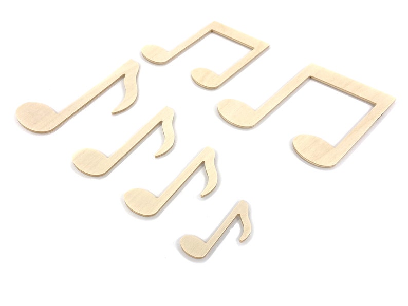May include: Six wooden music note shapes in various sizes, all in a light brown color. The notes are arranged in a random pattern on a white background.