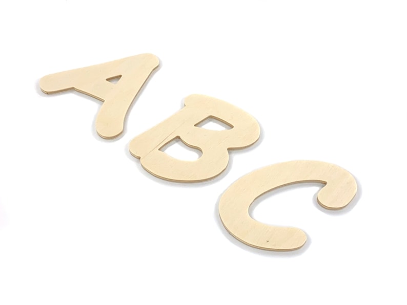 May include: Three wooden letters, A, B, and C, in a cursive font. The letters are painted a light brown color and are arranged in a row.