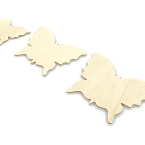 May include: Three unfinished wooden butterfly shapes in various sizes. The butterflies are arranged in a row from smallest to largest.