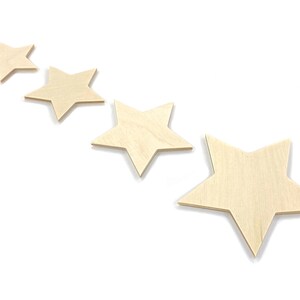 May include: Four unfinished wooden stars of varying sizes arranged in a row, with the largest star on the right and the smallest star on the left.