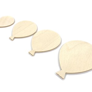 May include: Four unfinished wooden balloon shapes of varying sizes. The balloons are arranged in a row from smallest to largest.