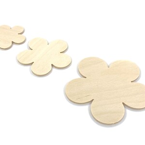 May include: Three unfinished wooden flower shapes in various sizes. The flowers are made of light brown wood and have a smooth surface.