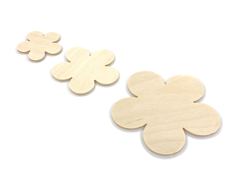 May include: Three unfinished wooden flower shapes in various sizes. The flowers are made of light brown wood and have a smooth surface.