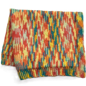 May include: A colorful knitted blanket with a striped pattern in shades of orange, yellow, green, and blue.