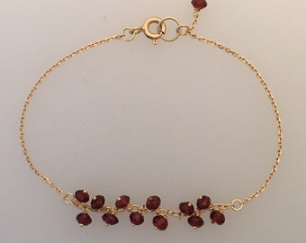 18k massivt guldkedjearmband med granat
