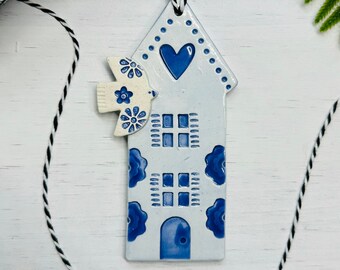 handmade dove flying over a Dutch house ceramic ornament