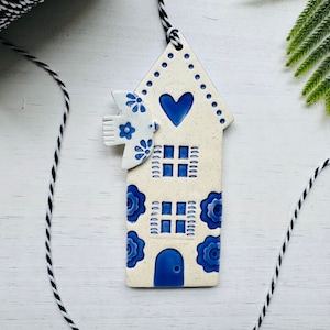 handmade pale blue bird flying over a Dutch house ceramic ornament image 1