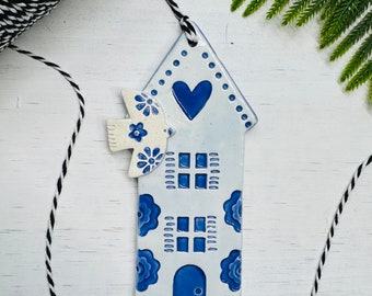 handmade dove flying over a Dutch house ceramic ornament