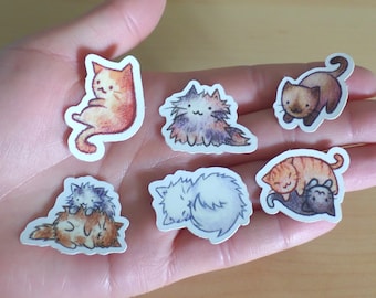 May include: A set of six colourful cat stickers featuring different poses and expressions. The stickers are printed on white paper and have a glossy finish.