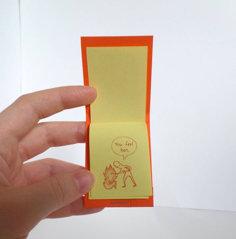 May include: A small orange card with a yellow note inside. The note has a cartoon drawing of a person with a speech bubble that says "You feel hot."