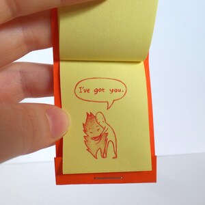 May include: A small orange and yellow book with the text "I've got you." and a red illustration of two figures hugging.