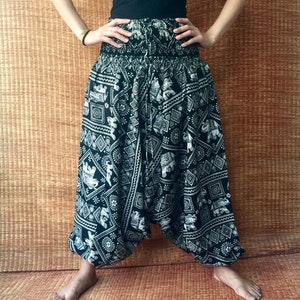 May include: Black and white printed pants with an elephant design. The pants are loose fitting and have a wide leg.