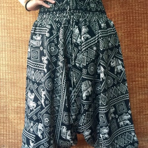 May include: Black and white patterned pants with an elephant design. The pants are loose fitting and have a wide leg.