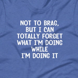 May include: A blue t-shirt with white text that reads "NOT TO BRAG, BUT I CAN TOTALLY FORGET WHAT I'M DOING WHILE I'M DOING IT".