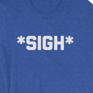 May include: A royal blue t-shirt with a white graphic that says "*SIGH*"