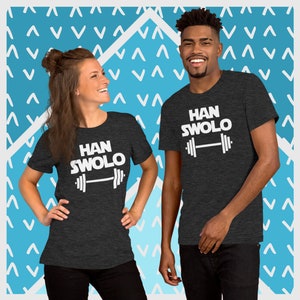May include: Two people wearing dark grey t-shirts with white text that says "HAN SWOLO" and a white barbell graphic.