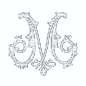 May include: A decorative, silver-coloured, stylised letter M with ornate flourishes.