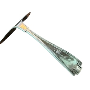 May include: Silver serving spoon with a decorative handle and the inscription "Brown & Co."