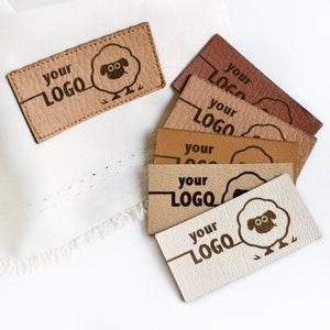 May include: Five different sized leather labels with the text "your logo" and a cartoon sheep design. The labels are in various shades of brown and beige.