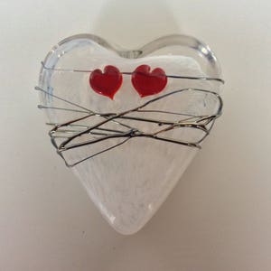 Glass heart with two red hearts