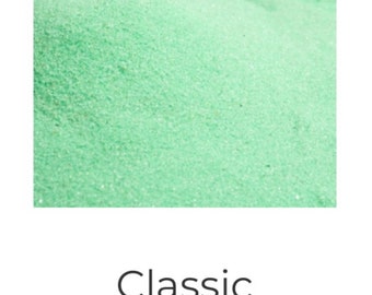 May include: A close-up of a pile of mint green colored sand. Classic Colored Sand - Mint.