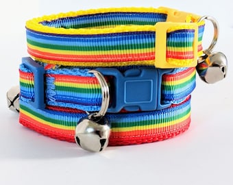 May include: Two rainbow striped cat collars with adjustable buckles and silver bells. The top collar is yellow and the bottom collar is blue.
