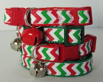 May include: Three red, white, and green chevron patterned cat collars with adjustable buckles and safety breakaway clasps. Each collar has a silver bell attached.