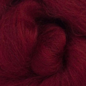 May include: A close-up of a deep red wool roving. The fibers are soft and fluffy, perfect for spinning or felting.