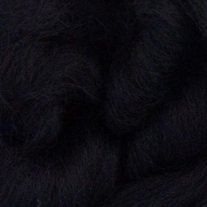 May include: A close-up of black wool roving, a soft and fluffy fiber used for spinning yarn, felting, and other crafts.