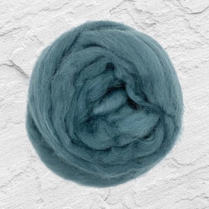 May include: A ball of teal blue wool roving. The wool is soft and fluffy, perfect for felting or spinning.