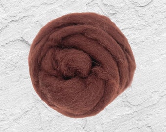 May include: A close-up of a ball of brown wool roving. The wool is soft and fluffy, and it is perfect for felting or spinning.