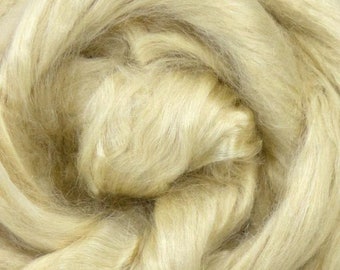 May include: A close-up of a pile of natural, light beige flax fiber. The fibers are soft and fluffy, and they are perfect for spinning or felting.