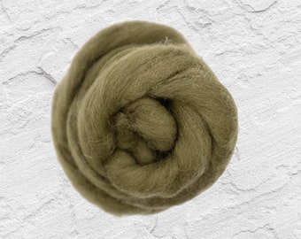May include: A close-up of a ball of olive green wool roving. The wool is soft and fluffy, and it is perfect for felting or spinning.
