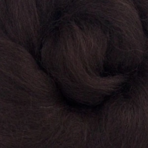 May include: A close-up of a dark brown wool roving. The wool is soft and fluffy, and it is perfect for felting or spinning.