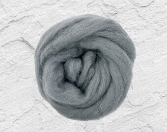 May include: A close-up of a ball of gray wool roving. The wool is soft and fluffy, and it is perfect for felting or spinning.