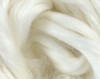 May include: Close-up of creamy white wool roving, showing the soft texture and natural fibers. The fibers are tightly spun, creating a smooth, consistent texture. Ideal for spinning, felting, or other fiber art projects.