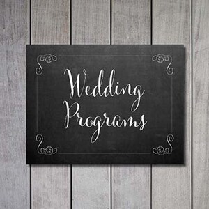 Puede incluir: Un letrero negro de pizarra con bordes decorativos blancos y el texto "Wedding Programs" escrito con tiza blanca.