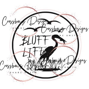 May include: Black and white graphic design with a heron standing in a marsh. The text "BLUFF LIFE" is written in a bold font. The design is surrounded by a circle with the text "Crossbow Designs Shari Smith" around the outside.