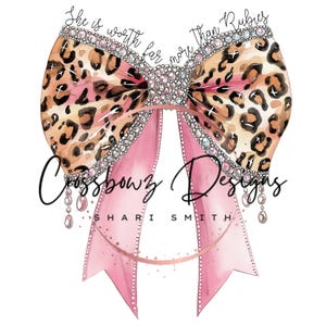 May include: A pink bow with a leopard print design and rhinestones. The bow has the text "She is worth far more than rubies" and "Crossbowz Designs Shari Smith" on it.