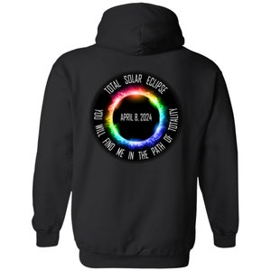 May include: Black hooded sweatshirt with a graphic print of a rainbow solar eclipse with the text "TOTAL SOLAR ECLIPSE APRIL 8, 2024 YOU WILL FIND ME IN THE PATH OF TOTALITY"