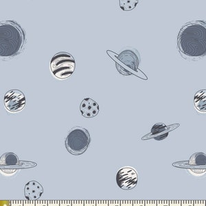 May include: A light blue fabric with a repeating pattern of planets and stars. The planets are drawn in black and white and have a whimsical, hand-drawn style. The fabric is perfect for quilting, sewing, and crafting.