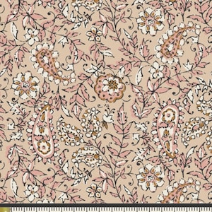 May include: A fabric with a repeating floral pattern. The design features paisley shapes, flowers, and leaves in shades of pink, white, and brown against a tan background. The pattern is measured with a ruler in inches.