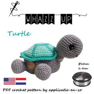 May include: A crochet pattern for a gray and teal turtle amigurumi toy. The pattern is available as a PDF download. The finished toy is approximately 10 cm in diameter and 4 cm tall.