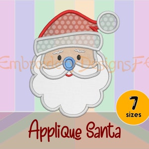 May include: Applique Santa embroidery design with a red hat with white polka dots, a white beard, and a blue nose. The design is available in 7 sizes.