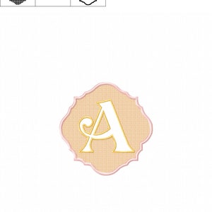 May include: A white letter A with a gold outline, in a decorative pink and beige frame. The letter is in a cursive font.