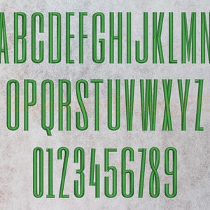 May include: Green embroidered alphabet letters and numbers on a white background. The letters are uppercase and the numbers are in a standard font.