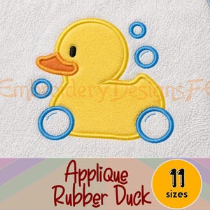 May include: Embroidered applique design featuring a yellow rubber duck with an orange beak and black eye, surrounded by blue bubbles. The design is on a white background with the text "Applique Rubber Duck" and "11 sizes".