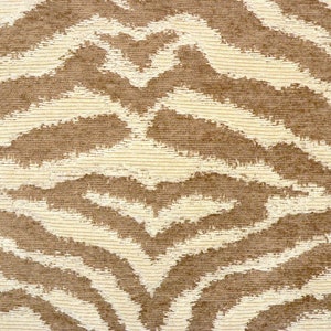 May include: A close-up of a brown and cream fabric with a zebra stripe pattern.