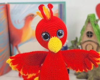 May include: A red crocheted bird with yellow accents and large blue eyes. The bird has outstretched wings and a long tail.